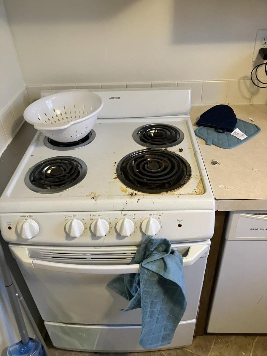 Before: a white electric range with stains and spills on the top