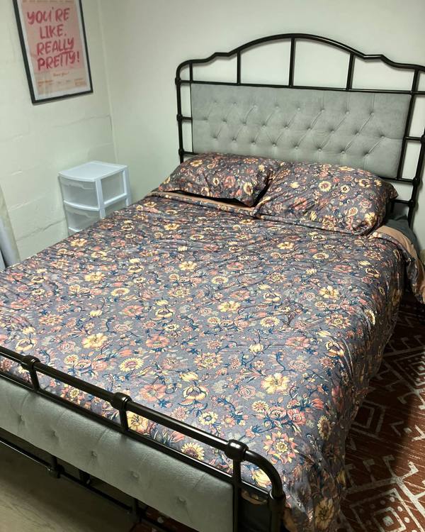A made bed with a floral cover
