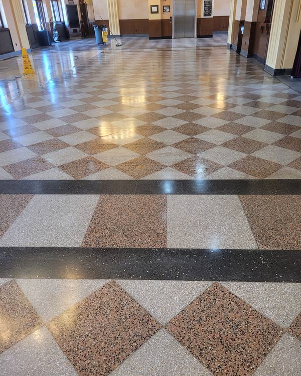 A terrazzo hall floor in a diamond pattern, freshly polished