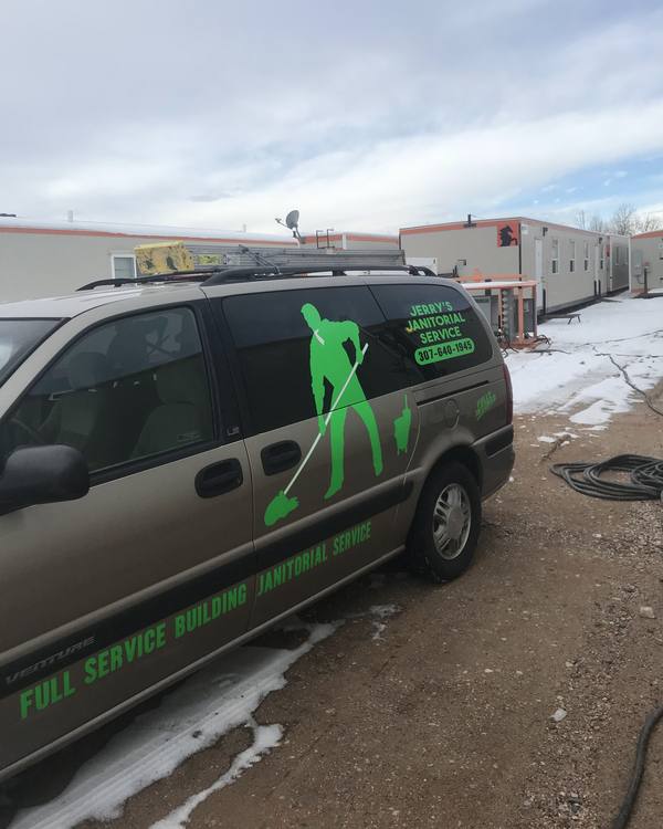 The work van with the green mopping figure on its side