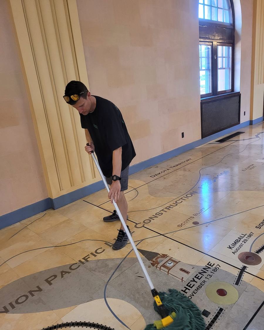 Mopping a floor inlaid with a map of the Union Pacific line through Cheyenne