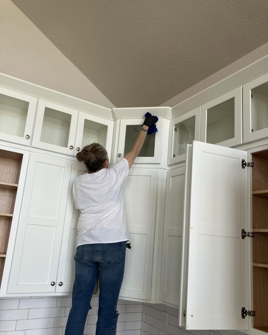 Wiping down white kitchen cabinets