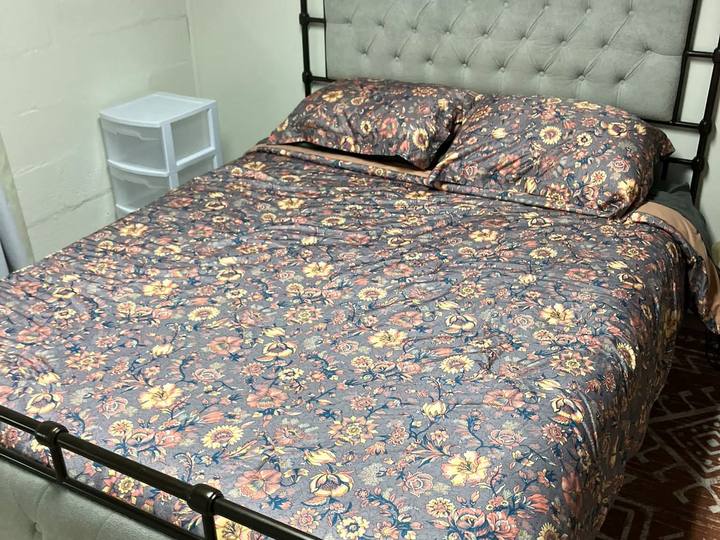 A made bed with a floral cover
