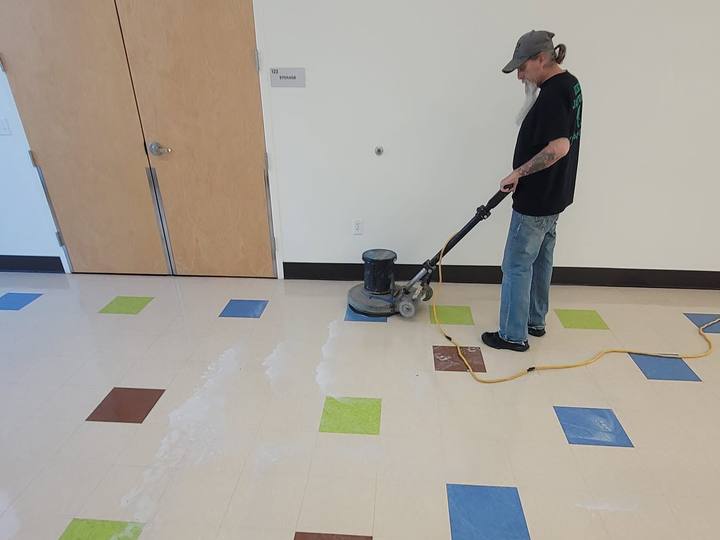 A floor machine running over colored tile