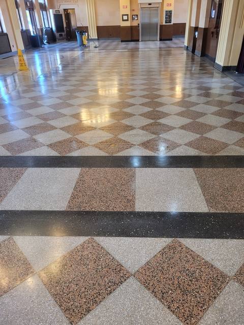 A terrazzo hall floor in a diamond pattern, freshly polished
