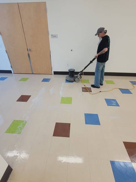 A floor machine running over colored tile
