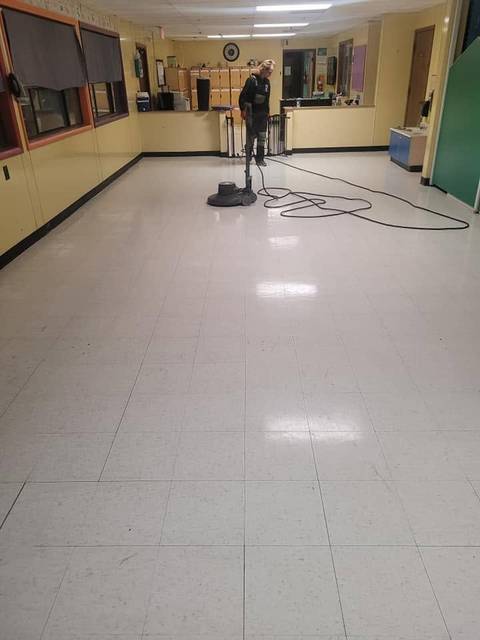 A big room of light tile being buffed