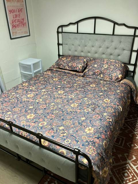 A made bed with a floral cover