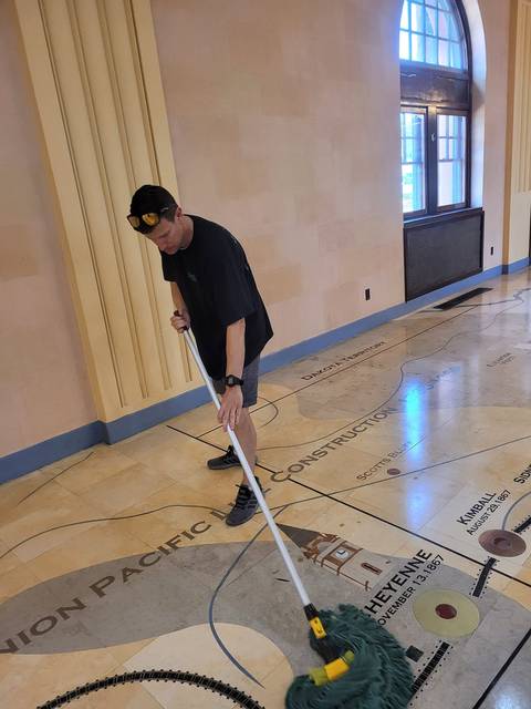 Mopping a floor inlaid with a map of the Union Pacific line through Cheyenne