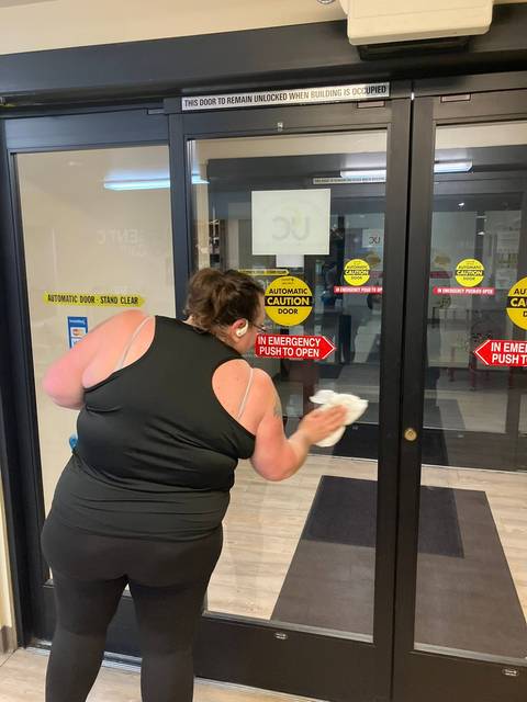 Wiping the glass entry doors of a building