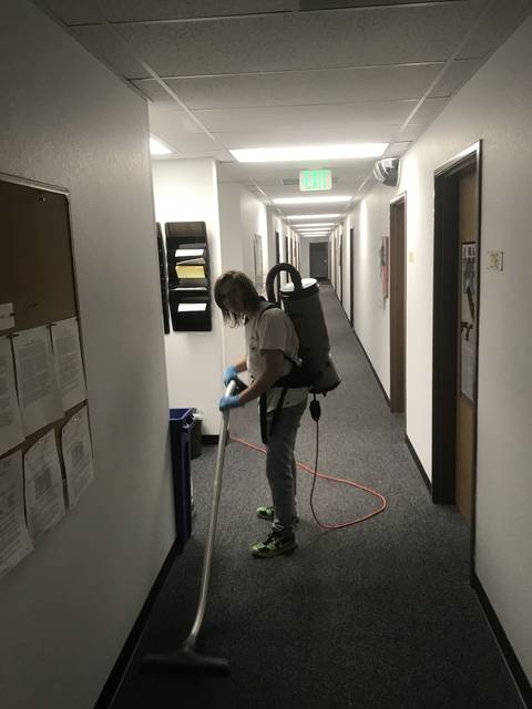 Vacuuming a long carpeted hallway
